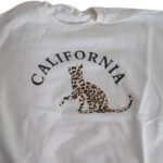Poleron infantil blanco con diseño de leopardo y texto "CALIFORNIA" - Imagen 3